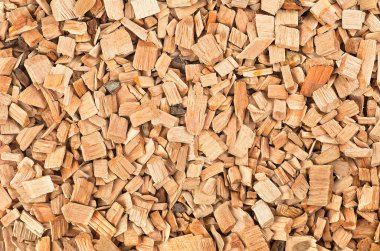 Wooden smoking chips as background, top view. Wood shavings for smoking meat and fish.