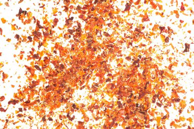 Dried tomato flakes as background, top view. Chopped tomatoes.