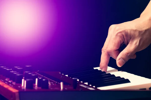 male musician hand playing on synthesizer keyboard. music background