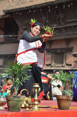 Nepalese woman dancing at the Kathmandu Darbar square. clipart