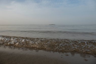 Sand beach, evening lake. Defocus