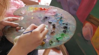 Sanatçı okulu resim yapmayı öğreniyor.
