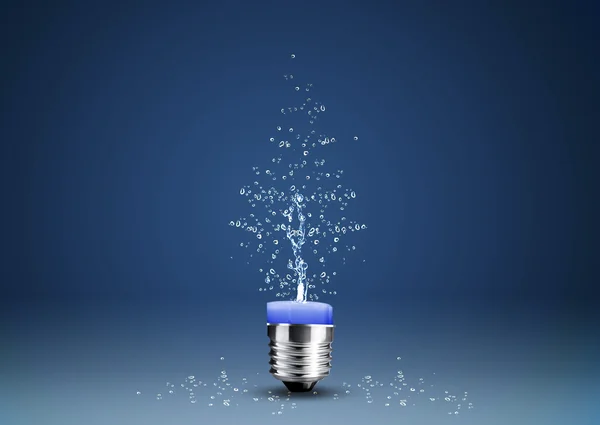 Wax candle into lighting bulb with water splashes — Stock Photo, Image