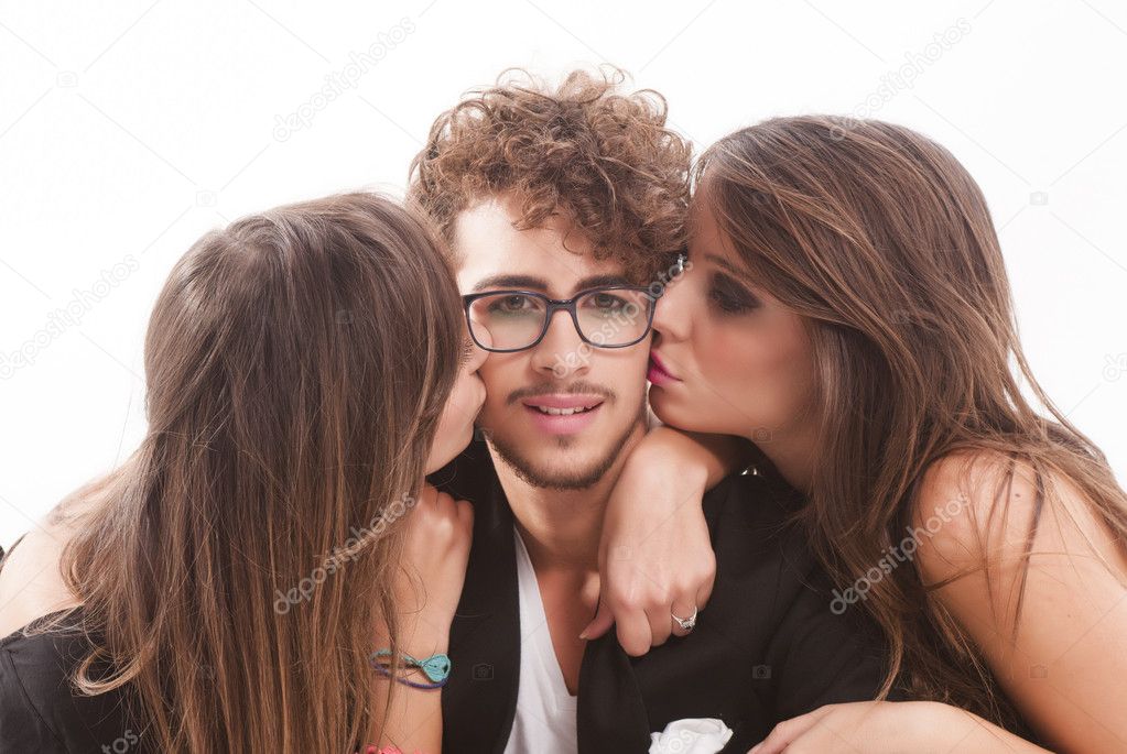 Two young attractive women kissing man