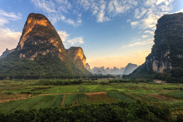 Sunrise over a valley of limestone hills — Stock Photo, Image