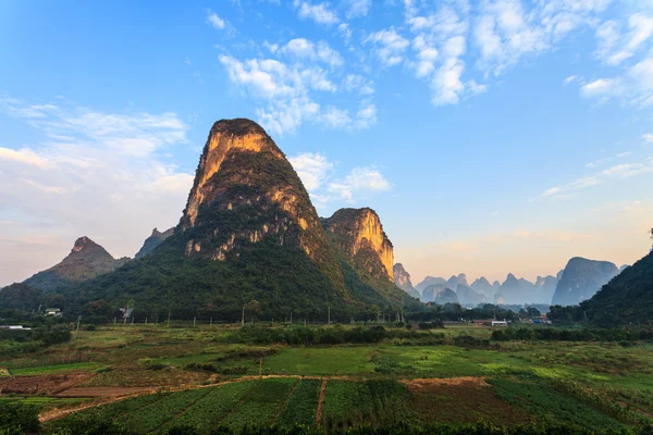 Sunrise over a valley of limestone hills — Stock Photo, Image