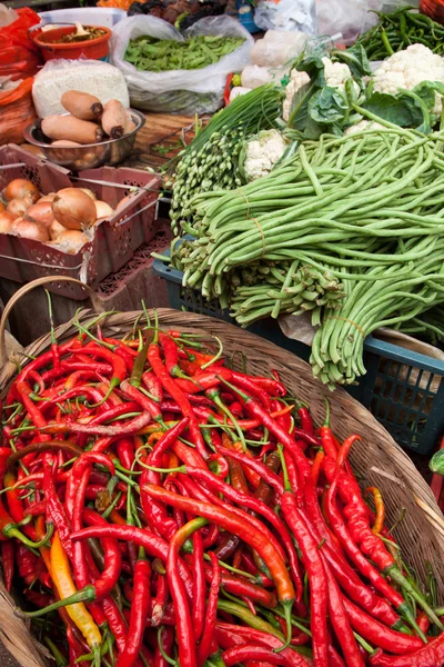 Red peppers in basket at a market — Stock Photo, Image