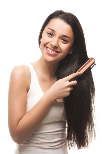 Menina bonita penteando seu cabelo — Fotografia de Stock