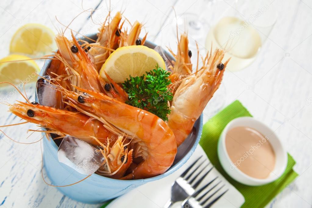 Bucket of king prawns on ice