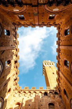 Interior courtyard and tower  of the city hall (in italian: Palazzo Comunale or Palazzo Pubblico) in Siena, Tuscany, Italy, Europe