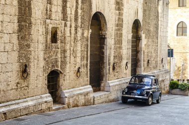 Dark blue Fiat 500 in front of an old building in the Italian city Gubbio, Umbria, Italy