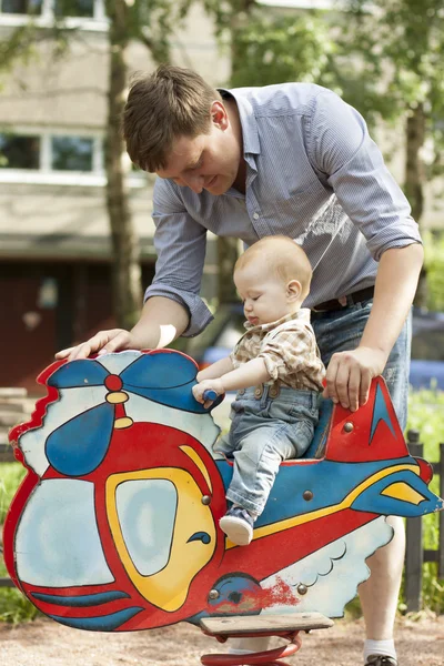 赤ちゃんの父親と息子の遊び場で楽しい時を過す — ストック写真
