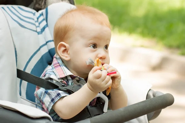 Cute 9 month baby boy chewing on toy — Stock Photo, Image