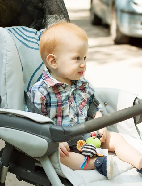 Adorable baby boy sitting in stroller — Stock Photo, Image