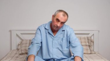 Yaşlı adam evde jimnastik egzersizleri yapıyor. Sağlıklı yaşam tarzı, fitness, eğlence, refah, emeklilik, yaşlılık kavramı.