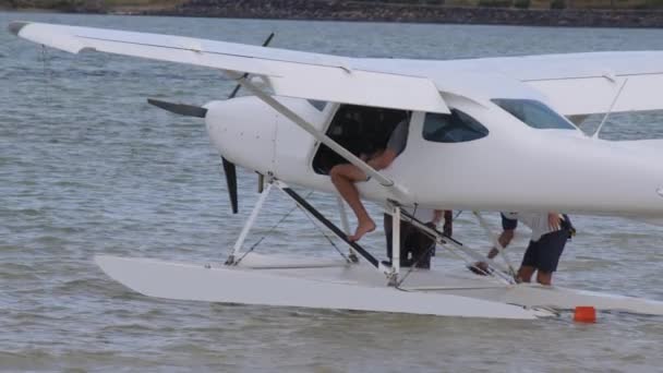 White hydroplane takeoff in a calm lagoon — Stockvideo