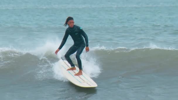 Tamarin, Mauritius, February 22, 2022: A surfer rides on a longboard along a wave. — Stock Video