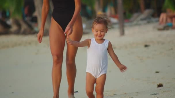 Zamknij portret pięknego dziecka. Włosy wieją na plaży w zwolnionym tempie. Uśmiecha się i jest atrakcyjna. — Wideo stockowe