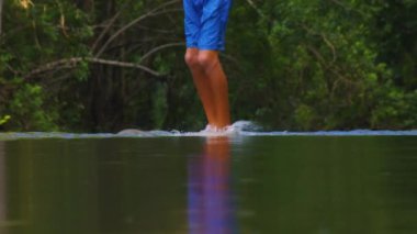 Gölün sahilinde dans eden ve spreyleyen genç bir çocuk. Gençler yaz parkında dans ederken eğleniyor.