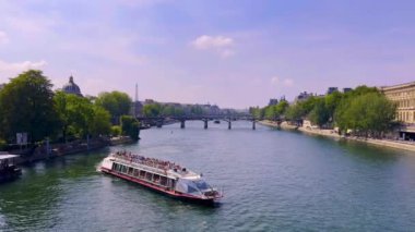 Paris, France, 28 july, 2022: People and cars move along the wide streets of Paris. Weekend, summer, sunny, hot day in the capital of France. Most popular tourist landmark in France. 4k footage