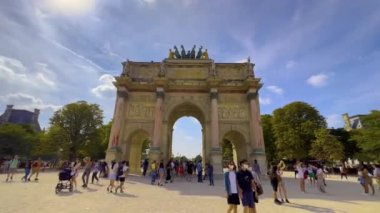 Paris, France, 30 july 2022: Paris famous crowded tuileries garden arch panorama. Lots of tourists walking around the city. High quality 4k footage