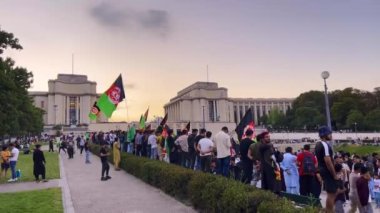 Paris, Fransa, 29 Temmuz 2022: Eyfel Kulesi yakınlarındaki kanat siyasi mitinginde Afgan bayrakları sallayan kalabalık. Paris 'in merkezinde Eyfel Kulesi yakınlarındaki bir mitingde Afgan adamlar. Afgan mülteciler protesto etti.