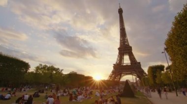 Timelapse, movement of clouds. People walk in Paris with the Eiffel Tower in the background. The most popular tourist attraction in the world. Paris, France. High quality 4k footage