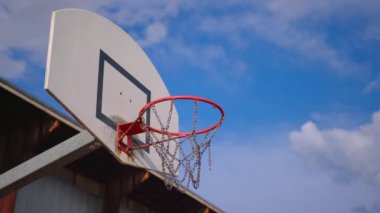 Young athletic male playing basketball outdoors. Young sports men practicing basketball on the outdoor court. High quality 4k footage