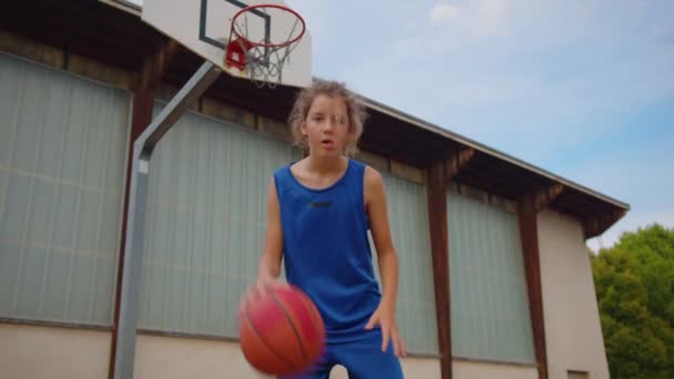 Boy Blue Basketball Uniform Plays Orange Ball Basketball Training School — 图库视频影像