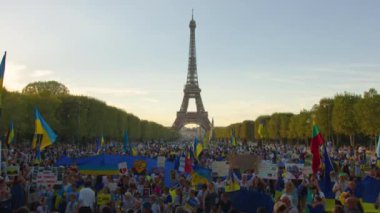 Paris, France, August 24 2022: People protesting against war, crowd waving flags. View of Ukrainian people protest on the streets of Paris against the war, people with flags. Independence Day.