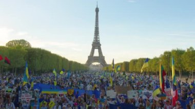 Paris, France, August 24 2022: Demonstration against war, crowd waving flags. View of Ukrainian people protest on the streets of Paris against the war, people with flags. Independence Day.