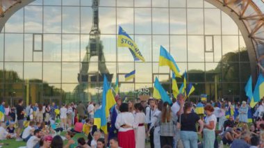 Paris, France, August 24 2022: Demonstration against war, crowd waving flags. View of Ukrainian people protest on the streets of Paris against the war, people with flags. Independence Day.