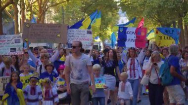 Paris, France, August 24 2022: Demonstration against war, crowd waving flags. View of Ukrainian people protest on the streets of Paris against the war, people with flags. Independence Day.