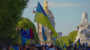 Paris, France, August 24 2022: Demonstration against war, crowd waving flags. View of Ukrainian people protest on the streets of Paris against the war, people with flags. Independence Day.