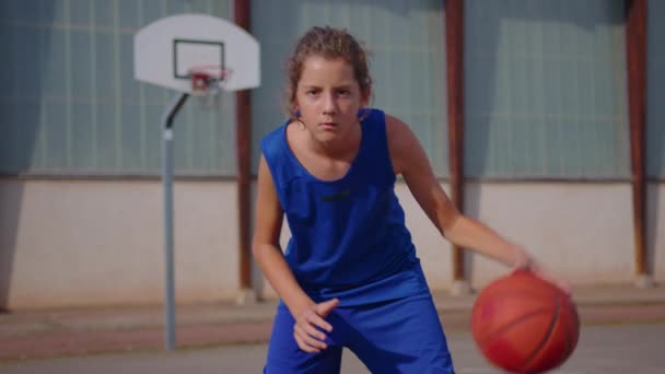 Boy Blue Basketball Uniform Plays Orange Ball Basketball Training School — 图库视频影像