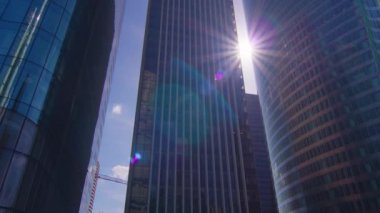 Business district building with blue sky and sun flare, La Defense Paris, France. High quality 4k footage