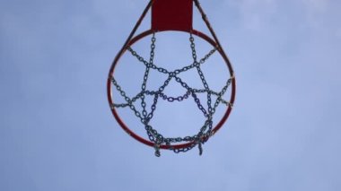 Young athletic male playing basketball outdoors. Young sports men practicing basketball on the outdoor court. High quality 4k footage