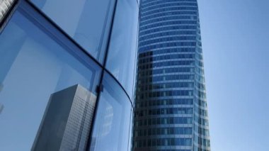 Building reflected on glass skyscraper in Paris, grey skyscraper in Paris, open glass at left, blue sky and reflections. Wide Shot. High quality 4k footage