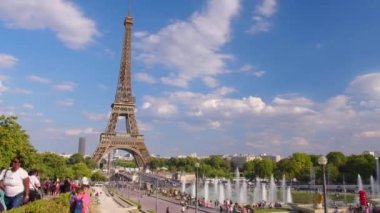 Timelapse, movement of clouds. People walk in Paris with the Eiffel Tower in the background. The most popular tourist attraction in the world. Paris, France. High quality 4k footage