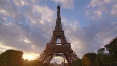 Timelapse, movement of clouds. People walk in Paris with the Eiffel Tower in the background. The most popular tourist attraction in the world. Paris, France. High quality 4k footage