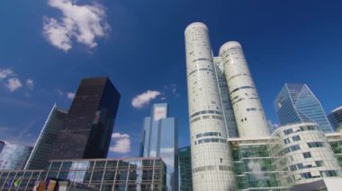Timelapse. Skyscrapers modern business and financial district in Paris with high rise buildings and convention center. Blue cloudy sky in summer day. Reflections. High quality 4k footage