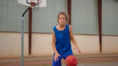 Young athletic male playing basketball outdoors. Young sports men practicing basketball on the outdoor court. High quality 4k footage