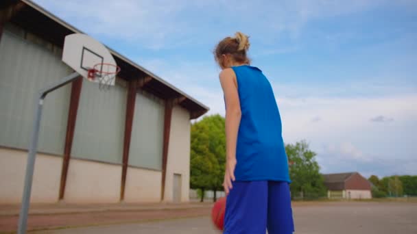 Boy Blue Basketball Uniform Plays Orange Ball Basketball Training School — 图库视频影像