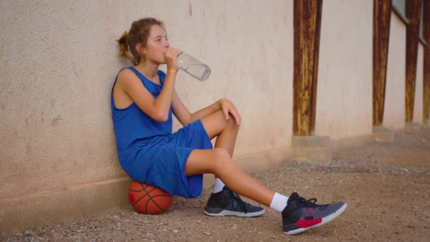 Portrait Satisfied Basketball Player Sitting Court Ball Drinking Fresh Cold — Stock Video