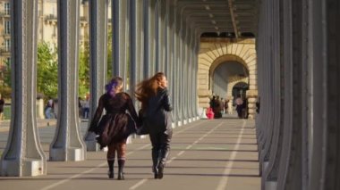 Paris 'te rahat bir uykudan gülen ve gülümseyen iki mutlu kız. Temiz havada iki kız arkadaşın aktifleşmesi. Yüksek kalite 4k görüntü