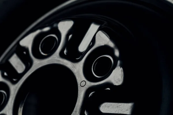 The black element of the car disk. Car wheel close-up
