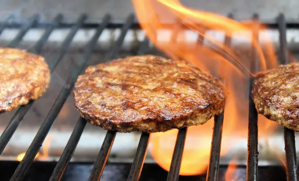Hambúrgueres fritando na grelha — Fotografia de Stock