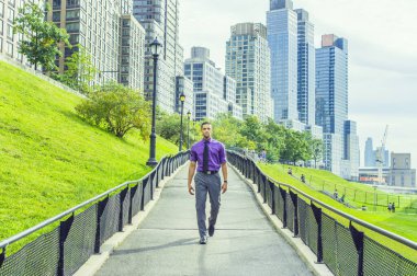Başarı Yolu. Genç ve yakışıklı bir adam, yoğun bir iş bölgesinden kendine güvenen bir şekilde yolda yürüyor.
