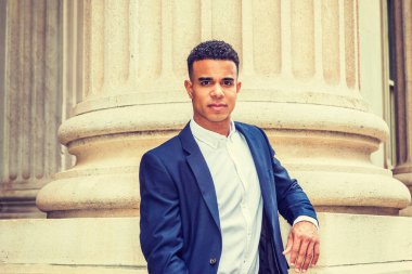 New York 'ta çalışan Afrikalı Amerikalı iş adamı. Mavi ceketli, beyaz tişörtlü, kampüsün dışında köşesinde durmuş, kendinden emin bir şekilde bekleyen siyahi bir üniversite öğrencisi.. 