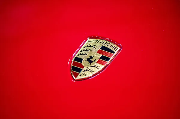 ラトビア 2021年9月24日 赤い車のフードにポルシェ社のロゴの表示 クローズアップ — ストック写真